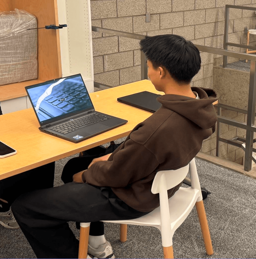A participant at a ThinkPad during a moderated session